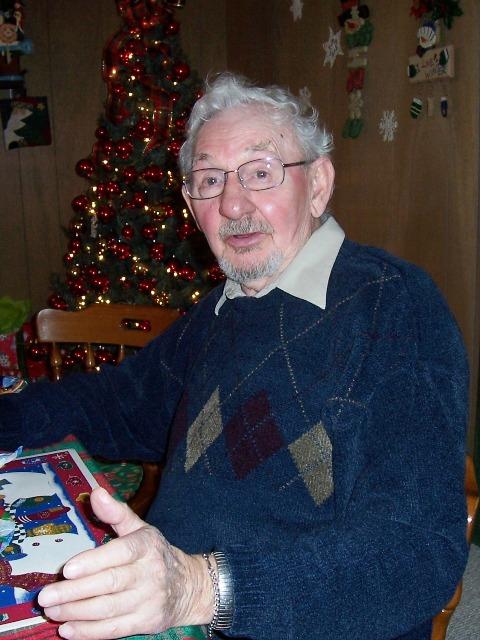 100_3383.JPG - Chet starting the evening's present opening.