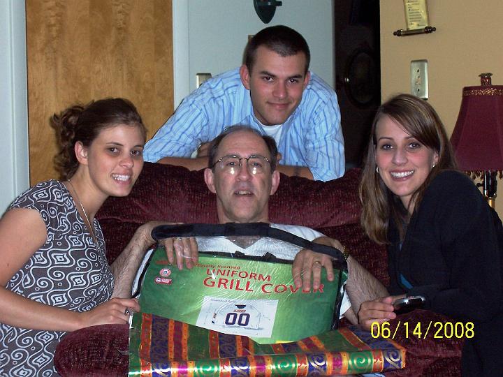 100_3759.JPG - Robin, Curtis, and Gina with Mark presenting his Father's Day present ... a Fighting Illini grill cover!