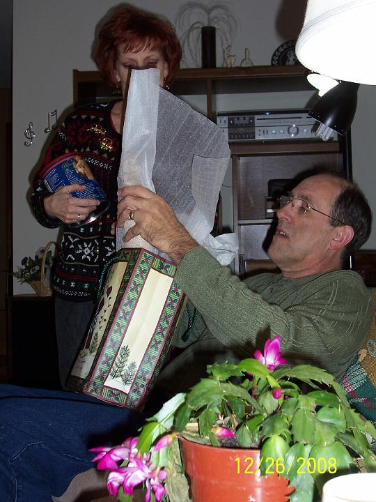 100_4357.JPG - Mark opening a present.