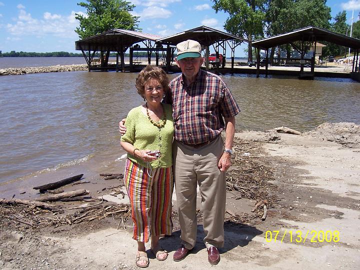 100_3828.JPG - Sharon and Chet at river's edge.  The water had been as high as the roofs of the boat docks in the background.