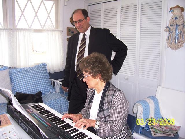 100_3477.JPG - Nana showing Mark how she's progressing on piano.