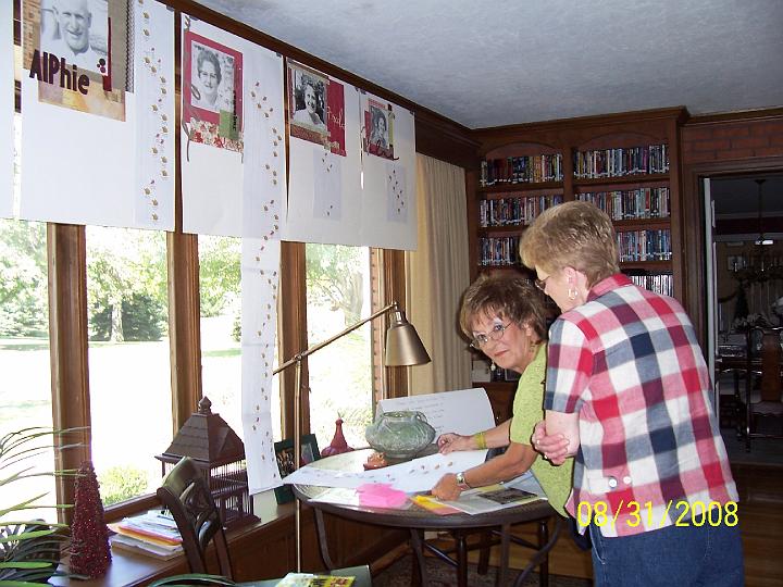 100_3891.JPG - Sharon and Georgia perusing the family trees.