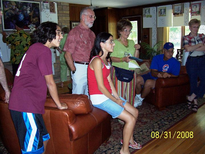 100_3894.JPG - Gathered around the TV watching a DVD of family pictures.