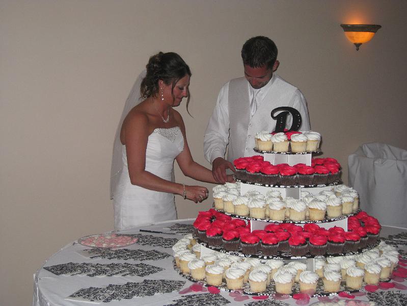 IMG_0738.JPG - Misty and Trevor digging into their wedding (cup)cake.