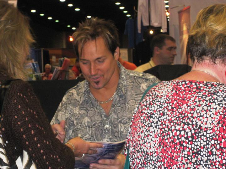IMG_1002.JPG - Michael English signing autographs in the Gaither booth.